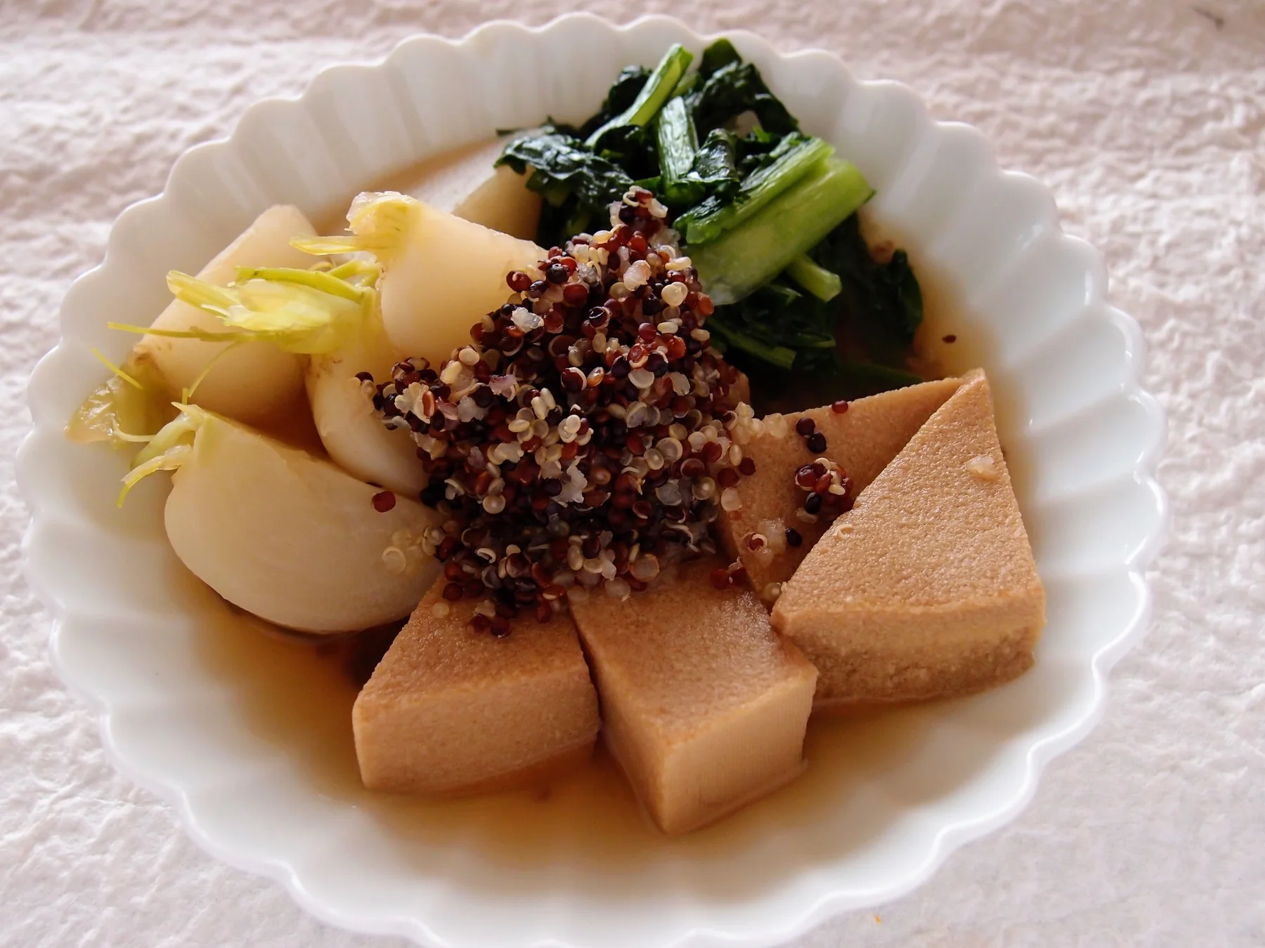 Japanese-style plant-based dish with simmered tofu, vegetables and grains