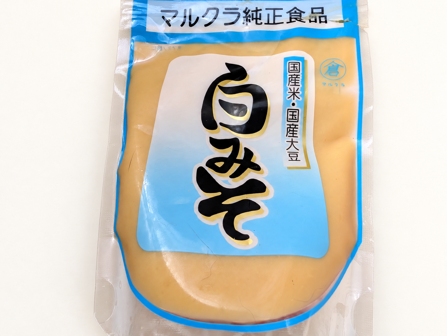 Package of Marukura white miso on a warm white background