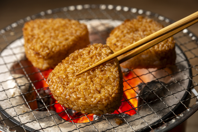 Grilled vegan yaki onigiri rice balls over charcoal